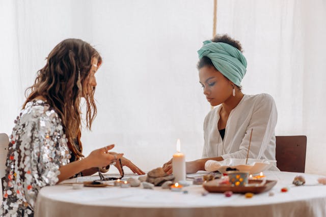 Two women doing a divination or spiritual practice.